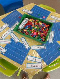 a table topped with lots of colorful plastic letters and small objects on top of it