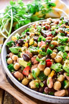 a white bowl filled with beans and veggies