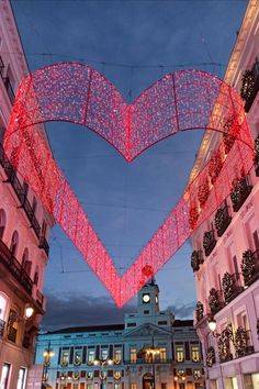 a large heart shaped building with lights hanging from it's sides