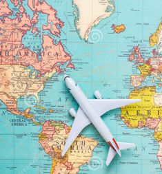 an airplane is sitting on top of the world map stock photo - image 397982