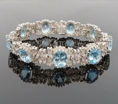 Title:                              Rare 47.0ct Natural Aquamarine & 3.01ct Diamond 18K White Gold Bracelet   Age/Markings:             New old stock                                         Diamonds:                   Approximately 3.01 carats of diamonds, H to I color, VS to SI clarity   Gemstones:                 Approximately 47.0 carats of natural aquamarine gemstones, bright blue color, good clarity   Metal:                            18K white gold                Weight: 43.8 grams   Measurements: 15mm wide, 7.5 inches long   Condition: New old stock condition   Description: Fine diamond & aquamarine 18K white gold bracelet with detailed decorations around the diamonds plus large natural aquamarine gemstones. This fine piece is in new old stock condition and the only wear it has seen White Gold Bracelet, Aquamarine Gemstone, Natural Aquamarine, Bracelets And Charms, Bright Blue, Vintage Watches, Aquamarine, Antique Jewelry, Diamond Bracelet