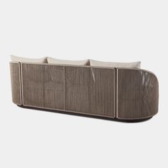 an outdoor sofa with four pillows on it's back and two sides facing each other