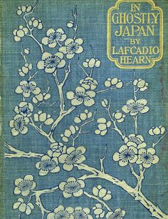 the front cover of an old book with white flowers on blue paper and yellow lettering