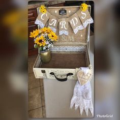 an old suitcase is decorated with flowers and burlocks