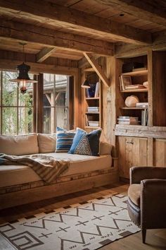 a living room filled with furniture and wooden walls