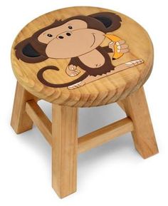 a wooden stool with a monkey painted on it