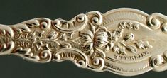 an antique silver spoon with ornate designs on it's sides and the words, campbell & co