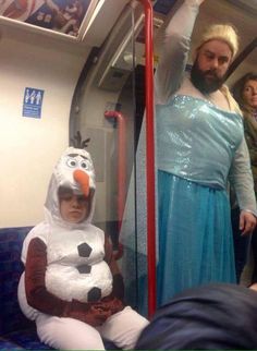 a man and woman dressed up as characters on a subway train, one is wearing a snowman costume