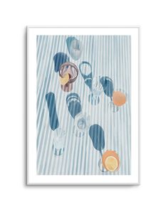 an art print with glasses and oranges on a striped tablecloth in white frame