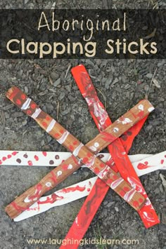 four wooden sticks that have been wrapped in red and white paper with the words, original clipping sticks