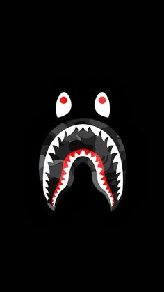 a shark's mouth with red eyes and sharp teeth on it, against a black background