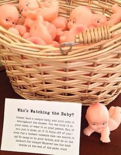 there is a basket full of small plastic pigs in it and a sign that says, who's watching the baby?