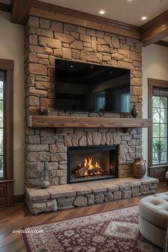 a living room with a stone fireplace and flat screen tv mounted on the wall above it