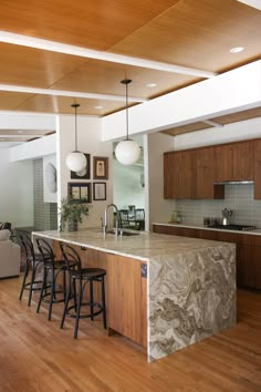 a large kitchen with an island in the middle and lots of counter space on each side