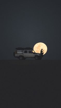 a truck is parked in front of the moon