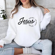 Elevate your everyday wardrobe with our stylish Jesus the Way Truth Life Hoodie, a John 14 6 inspired sweatshirt for Christians. These cozy essentials are perfect for showcasing your faith with a modern twist. Crafted from high-quality materials, these pieces are both comfortable and fashionable, making them ideal for any casual outing or cozy night in. Embrace your Christian beliefs in a trendy way with our Jesus the Way Christian Hoodie or Crewneck Sweatshirt.  OUR SHOP  Please be sure to visi Cozy Essentials, Christian Crewneck, Biblical Inspiration, Cozy Night, Christian Clothing, Everyday Wardrobe, Fleece Hoodie, Custom Clothes, Mens Sweatshirts