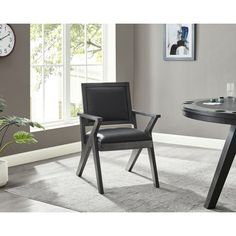 a black table with two chairs and a clock