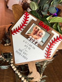 a baseball themed photo frame with an image of a baby on it