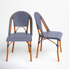 two wooden chairs with blue and white patterned upholstered seats, side by side