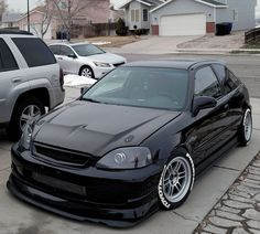 a black car parked on the side of a street