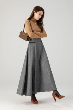 This grey winter wool skirt is a classic piece of tailoring that will see you through rain or shine. It is cut with a flattering flared skirt to give you a wonderful shape. The winter skirt is perfect classic styling and ends at the ankle.  DETAILS: * 30% wool, 30% fiber, 40% polyester * Fully satiny liner * Two side pockets * Right zipper closure * Maxi wool skirt,long skirt * A line skirt, swing skirt * High waist skirt * Daily skirt * Perfect for Winter, autumn * Dry clean * Lean More about the items From the FAQs on the page bottom MODEL SIZE Bust 85 cm(33.4") Waist 67 cm(26.7") Height 168cm (5' 6") She wears size XS Choose CUSTOM Order if you * Need a better fit * Can't find your size in our size Chart * Change the Style * Chang the Length * Your Height is not Between 5'1" - 5"9" * Yo Winter Wool Skirt, Custom Skirt, Long Wool Skirt, Classic Capsule Wardrobe, Skirt A Line, Maxi Skirt Outfits, Ankle Length Skirt, Skirt High Waist, Wool Clothing