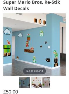 an empty room with blue walls and nintendo wall decals on the walls, along with wooden flooring