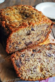 two slices of banana bread sitting on top of a wooden cutting board