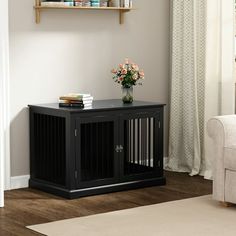 a living room with a dog crate on the floor