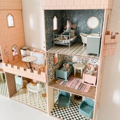 a doll house with furniture and accessories inside