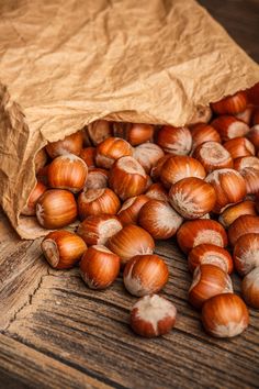 a bag full of nuts sitting on top of a wooden table