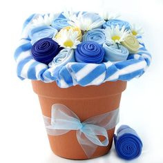 a flower pot filled with blue and white flowers