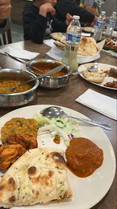 several plates of food on a wooden table