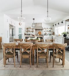 a dining room table surrounded by wooden chairs