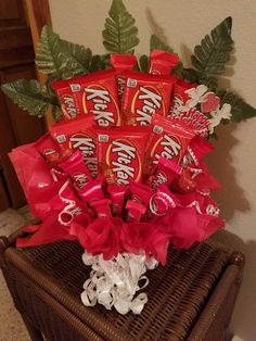 a basket filled with candy bar wrapped in red ribbon