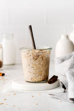 a glass jar filled with oatmeal sitting on top of a white counter