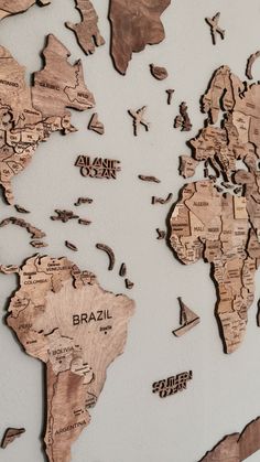 the world map is made out of wooden pieces