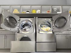 the front load washer and dryer are stacked into each other in this laundry room