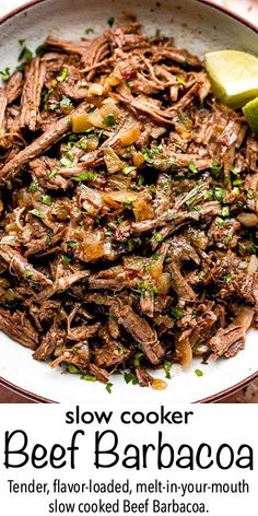 a bowl filled with beef and onions next to a lime wedge