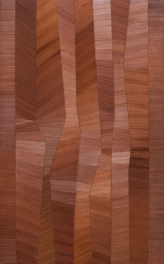 an image of wood textured with different colors and shapes in the form of wavy lines