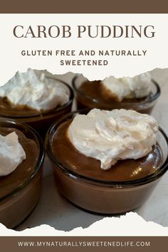 four desserts with whipped cream on top in small glass bowls, sitting on a table