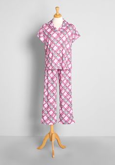 You’ll be lounging and sleeping in retro-fab style when you don this bright and boldly printed pink sleep set ! Featuring a vintage-inspired, all over plaid print made-up of rose pink, turquoise blue, and brown hues atop a baby pink background, this ModCloth-exclusive pajama set features a short sleeve, button-up collared top with matching pants. So classic, cute, and comfy, this super soft, cotton-viscose blend jersey knit PJ duo is sure to preclude dreams full of sugarplum fairies. 60% Cotton, Baby Pink Background, Vintage Style Swimwear, Gingham Embroidery, Casual Dresses Plus Size, Plus Size Sleepwear, Midi Dress Plus Size, Tunic Hoodie, Collared Top, Plaid Outfits