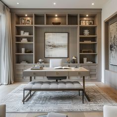 a home office with built in bookcases and a large painting on the wall