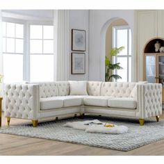 a white couch sitting on top of a rug in a living room