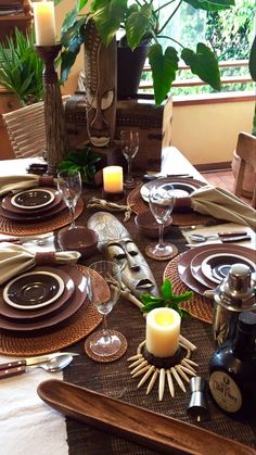 a table set with place settings and candles