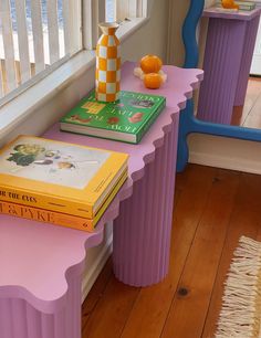 three books are stacked on the end tables