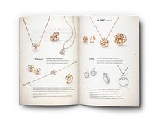 an open book with various jewelry items on the page and in it's center