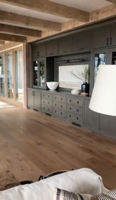 a living room filled with furniture and a flat screen tv on top of a wooden table