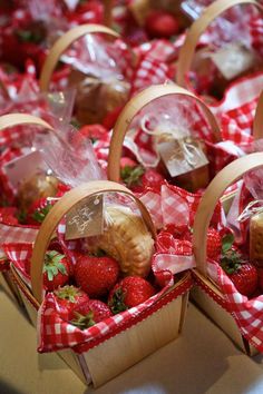 baskets filled with strawberries sitting on top of a table