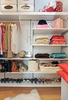 an organized closet with clothes and shoes