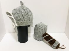 a crocheted hat and mitten are on display